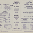 Load image into Gallery viewer, A printed restaurant menu page with multiple columns of text listing dishes, prices, and reservation information under headings such as Rainbow Trout, Shrimps de Jonge, Baked Oysters, and Children's Meal.
