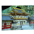 Load image into Gallery viewer, Front cover of a photo booklet detailing "The Nikko Shrines and their Models," an exhibition in Hawaii visited by passengers aboard the S.S. Matsonia. Shows a scenic architectural scene with ornate golden-roofed buildings, red details, gray roofs, and green foliage, placed on a wooden surface.
