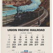 Load image into Gallery viewer, Vintage Union Pacific Railroad calendar page from June 1969, featuring a painted steam train traveling through a canyon landscape above a printed calendar grid and railroad crest.
